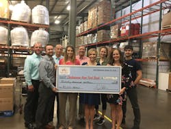 At the Chattanooga Area Food Bank Warehouse, President and CEO Gina Crumbliss (center right) and Director of Development Sarah Aligo (front row, far right) and team receives a donation from Danelle Layton (center left) and C.J. Recher (front row, far left) of the Five Star Food Services Team on behalf of Feeding the Future.