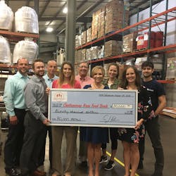 At the Chattanooga Area Food Bank Warehouse, President and CEO Gina Crumbliss (center right) and Director of Development Sarah Aligo (front row, far right) and team receives a donation from Danelle Layton (center left) and C.J. Recher (front row, far left) of the Five Star Food Services Team on behalf of Feeding the Future.