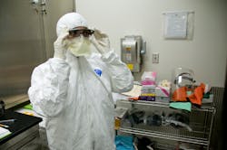 An FDA microbiologist prepares to conduct tests for high risk pathogens in a biosafety laboratory. An FDA microbiologist prepares to conduct tests for high risk pathogens in a biosafety laboratory.
