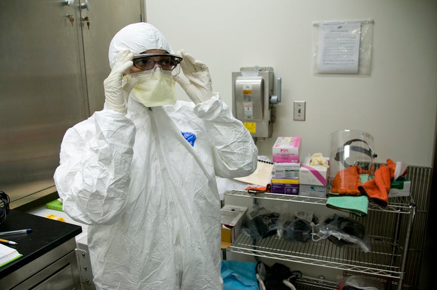 An FDA microbiologist prepares to conduct tests for high risk pathogens in a biosafety laboratory.