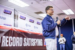 Mars Wrigley representative Ruud Engbers unveils the largest SNICKERS bar ever created Thursday, Jan. 16, 2020, in Waco, Texas. The more than two tons chocolate nut bar was made using a 1200 pound combination of caramel, nougat and peanuts, and 3500 pounds of chocolate.