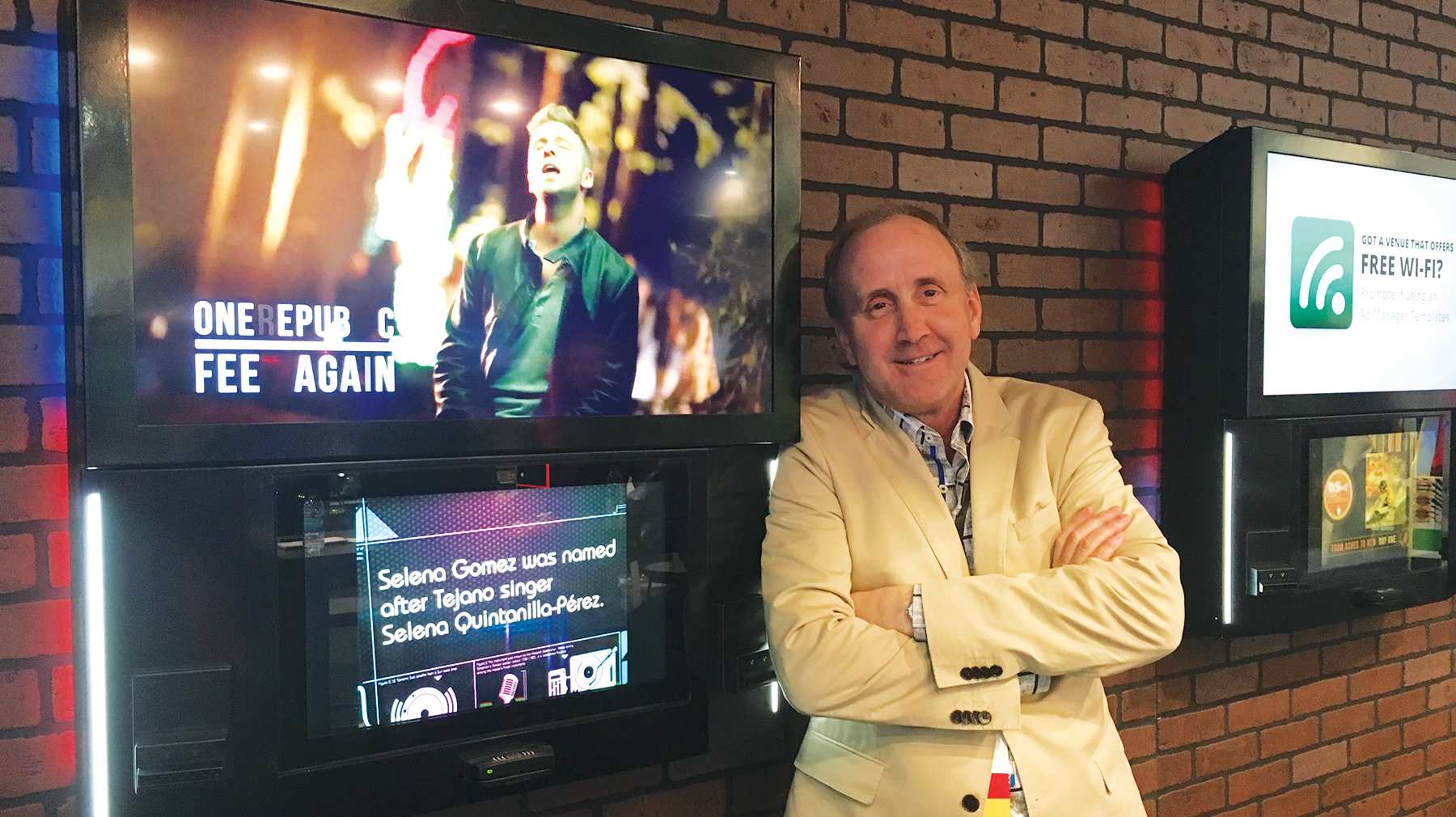 Mike Maas is pictured with AMI Entertainment's NGX Ultra wall-mount jukebox.