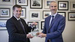 Waterlogic official presents Oceansaver award to Olly Craughan, DPD&apos;s head of corporate social responsibility.
