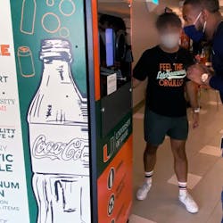 New reverse vending machine is pictured with recyclers in Hurricanes Food Court at University of Miami on America Recycles Day, Nov. 15.