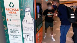New reverse vending machine is pictured with recyclers in Hurricanes Food Court at University of Miami on America Recycles Day, Nov. 15.