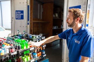 Giambra shows a new employee how to stock a truck for optimal organization and efficiency.