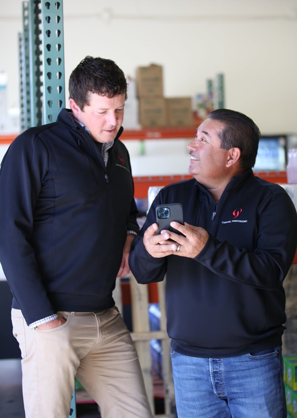 Director of route operations, Franco Benitez (right), talks Michael Lovett through a warehouse pick list for one of the day&rsquo;s stops.