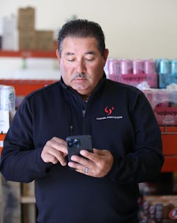 Director of route operations, Franco Benitez, checks a device to ensure service representatives have all the data they need at their fingertips to make merchandising decisions on the fly in the field. Director of route operations, Franco Benitez, checks a device to ensure service representatives have all the data they need at their fingertips to make merchandising decisions on the fly in the field.