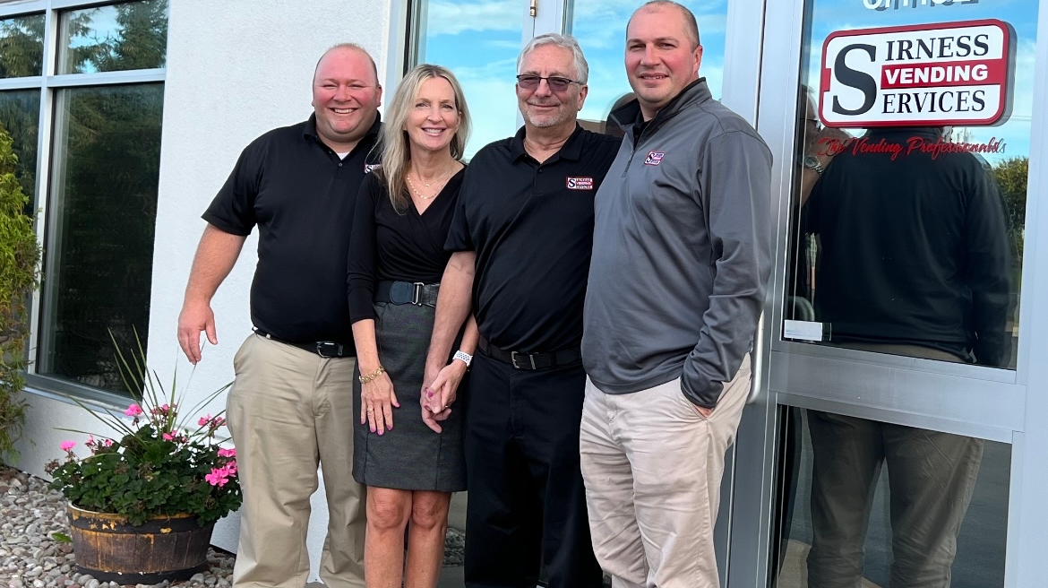 Larry Bach, Barbie Nesser, Tom Nesser and Tom Bach at the main entrance of their Rochester, New York, headquarters.
