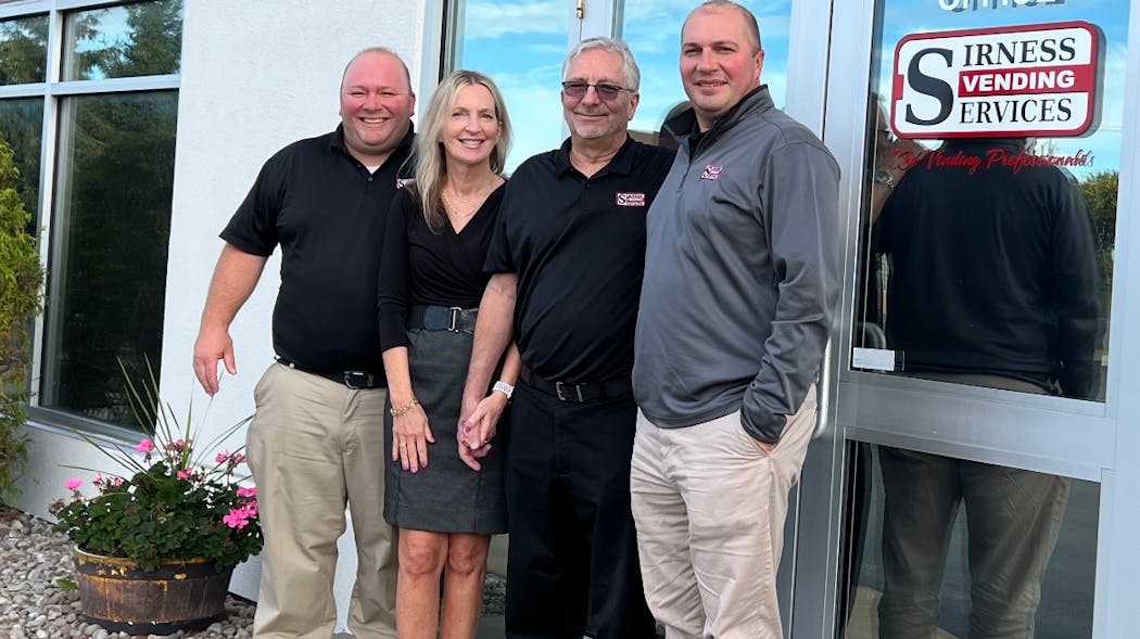 Larry Bach, Barbie Nesser, Tom Nesser and Tom Bach at the main entrance of their Rochester, New York, headquarters.