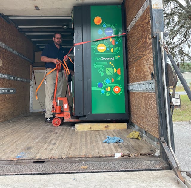 Norman Scalf readies a PepsiCo Hello Goodness-branded machine with better-for-you products that meet school nutrition standards for delivery.