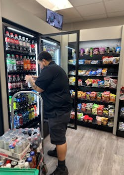 Delivery driver Isiah restocks an Executive Refreshments micro market. Delivery driver Isiah restocks an Executive Refreshments micro market.