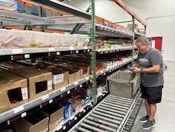 Quality Vending&apos;s Al Christofano pulling snacks in the warehouse.