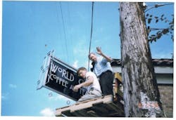 Don Welch and Steve Williams erecting the sign at their first coffee shop in 1999.