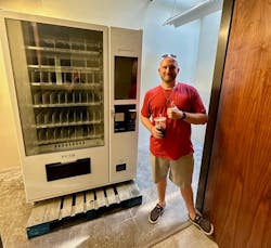 Mike Jamison standing next to a recently unboxed NewAge vending machine. Mike Jamison standing next to a recently unboxed NewAge vending machine.