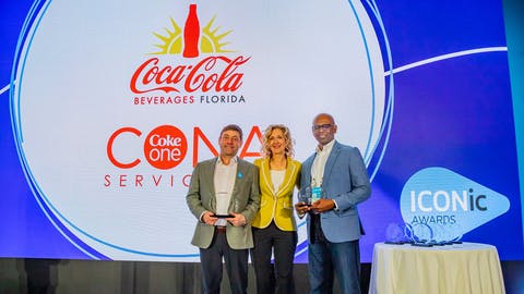 Terrence Gee, (right) senior vice president, Technology and Enterprise Transformation for Coca-Cola Beverages Florida, LLC, accepts the Blue Yonder 2024 ICONic Award for Supply Chain Resiliency. He is joined by (left-right) Baron Jordan, chief product officer - supply chain, CONA Services LLC and Susan Beal, chief customer officer, Blue Yonder. (Photo: Business Wire)