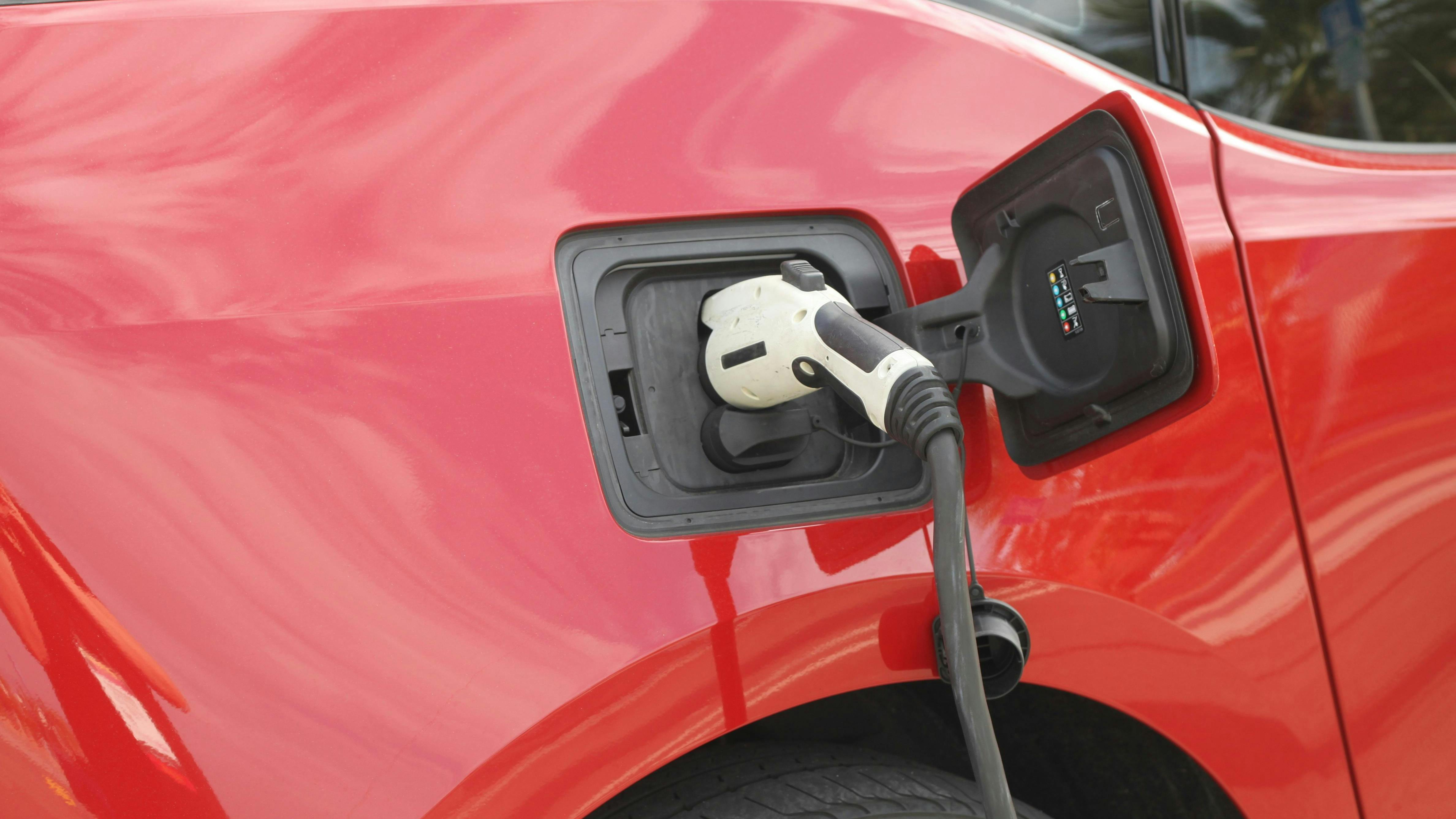 Red car electric vehicle charging