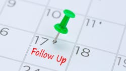 Follow Up written on a calendar with a green push pin to remind you and important appointment Follow Up written on a calendar with a green push pin to remind you and important appointment