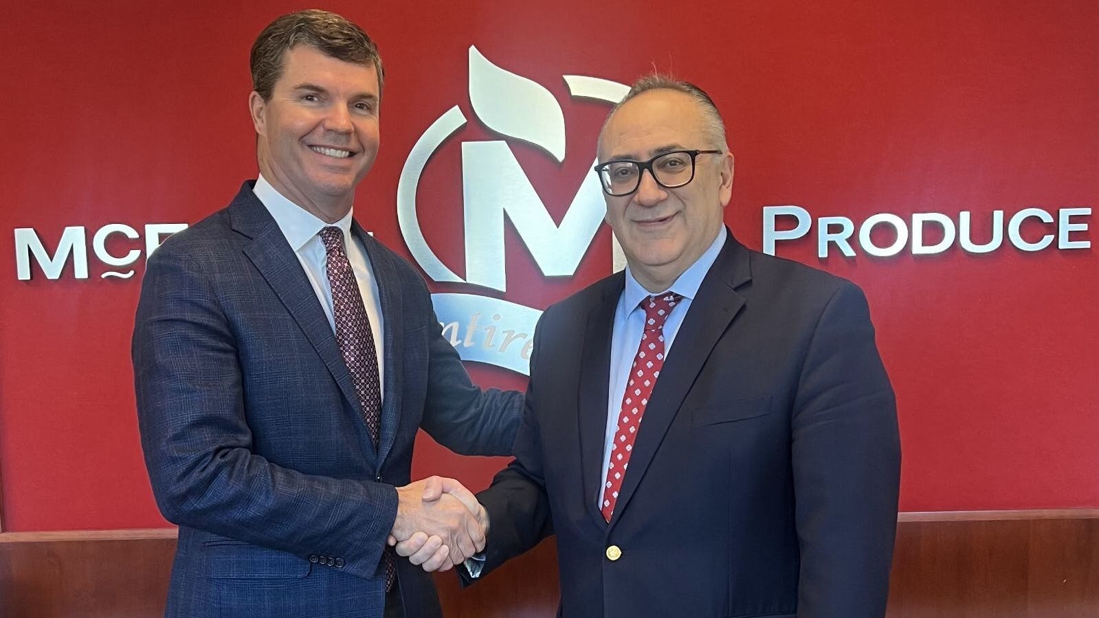 John P. Olivo, president of Fresh Express, and Carter McEntire, the newly appointed vice president of foodservice for Express, shake hands following the successful acquisition of McEntire Produce by Fresh Express.