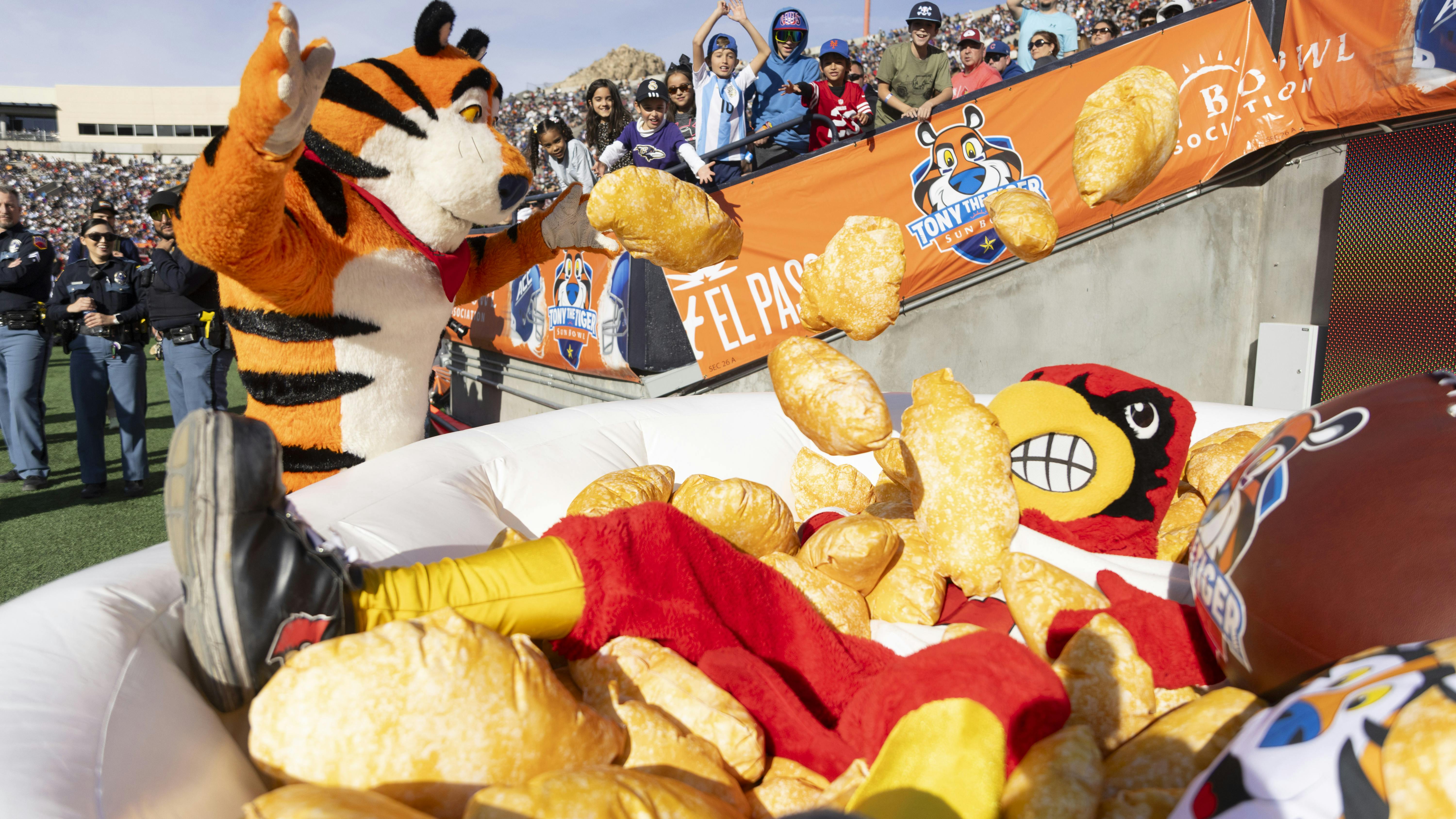 Tony the Tiger and Louie the Cardinal, the Louisville mascot, play in a bowl of Frosted Flakes at the Tony the Tiger Sun Bowl on Tuesday, Dec. 31, 2024, in El Paso, Texas.