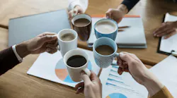 high-angle-people-cheering-with-coffee-mugs-office-meeting