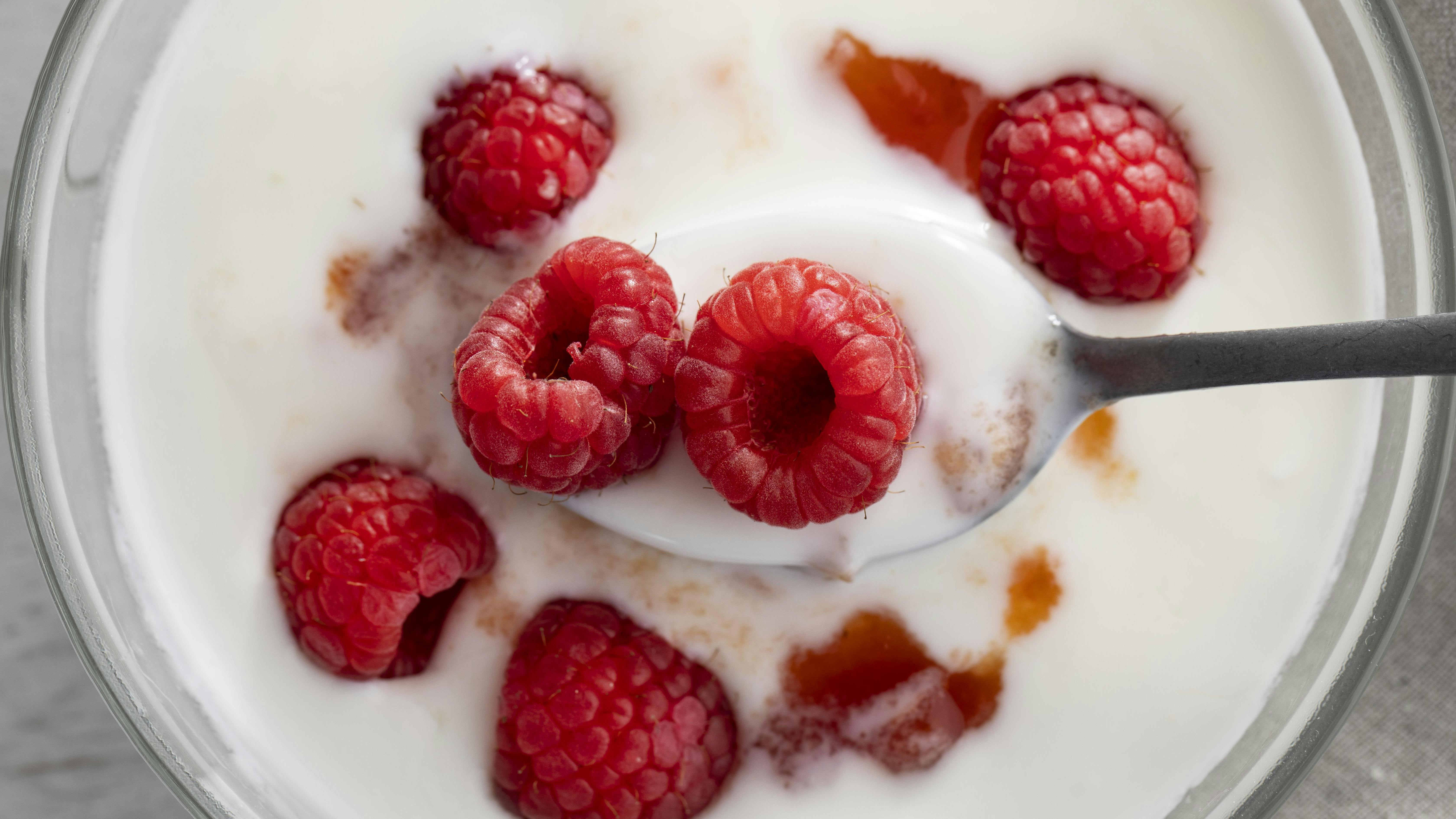 Yogurt with raspberries on top stock image