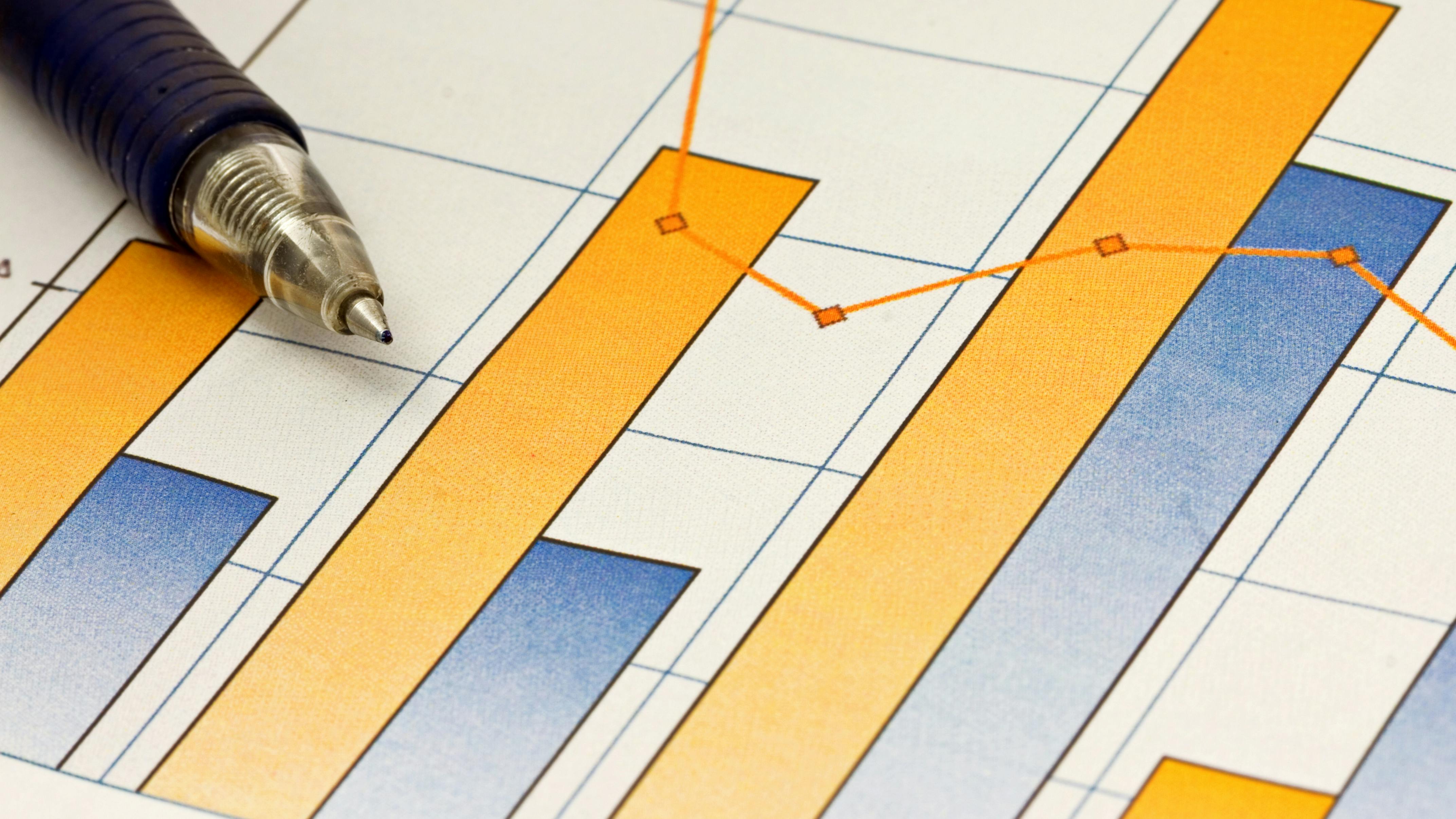 A pen composed over a business chart of earnings trends. dreamstime_xxl_17028850