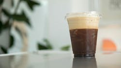 cold brew coffee served in a plastic cup with ice cold brew coffee served in a plastic cup with ice