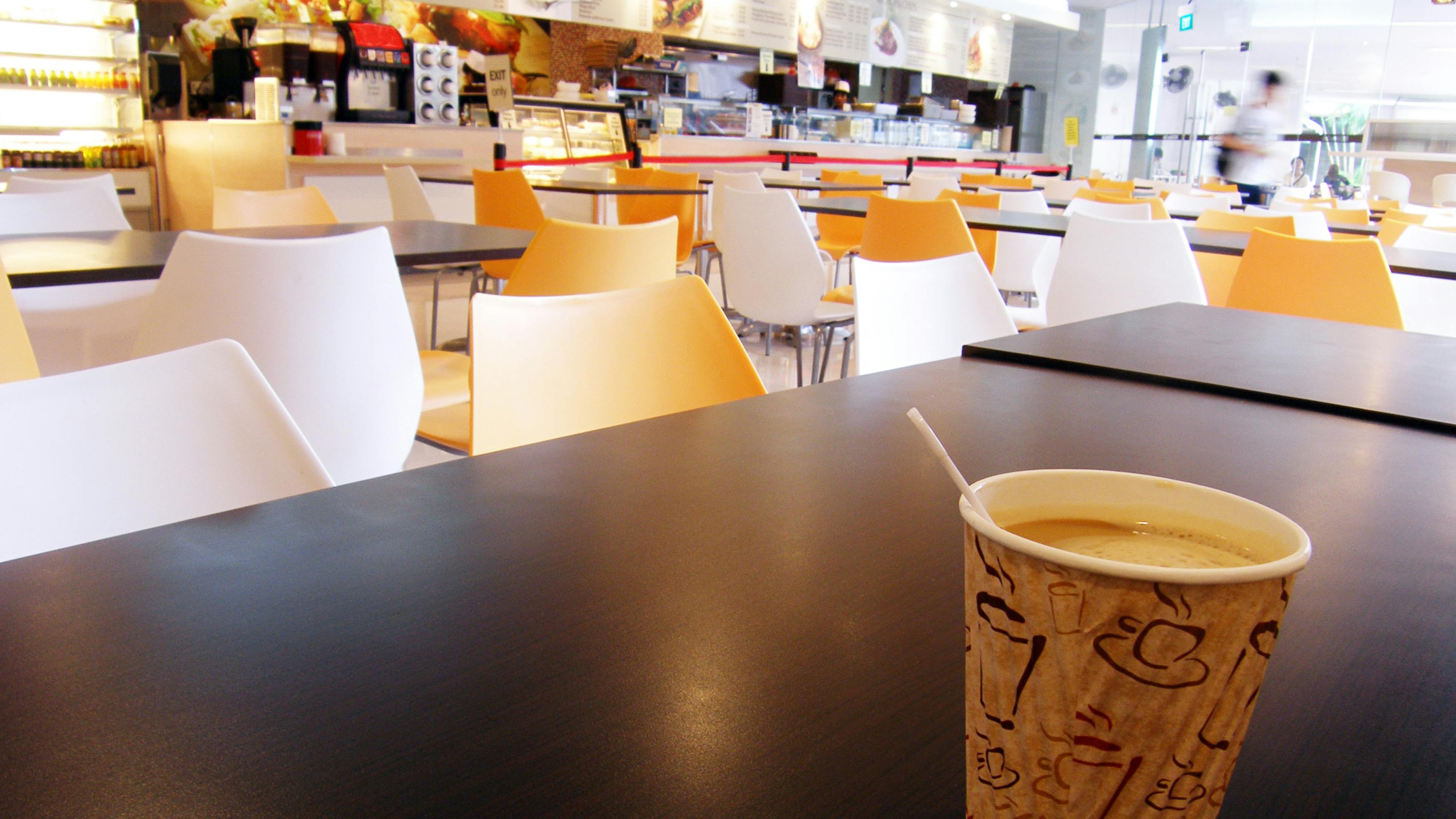 Cafeteria Table With Cup Of Hot Coffee