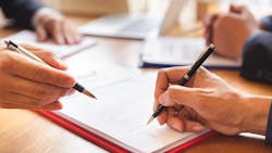 hands signing documents; business deal stock image hands signing documents; business deal stock image