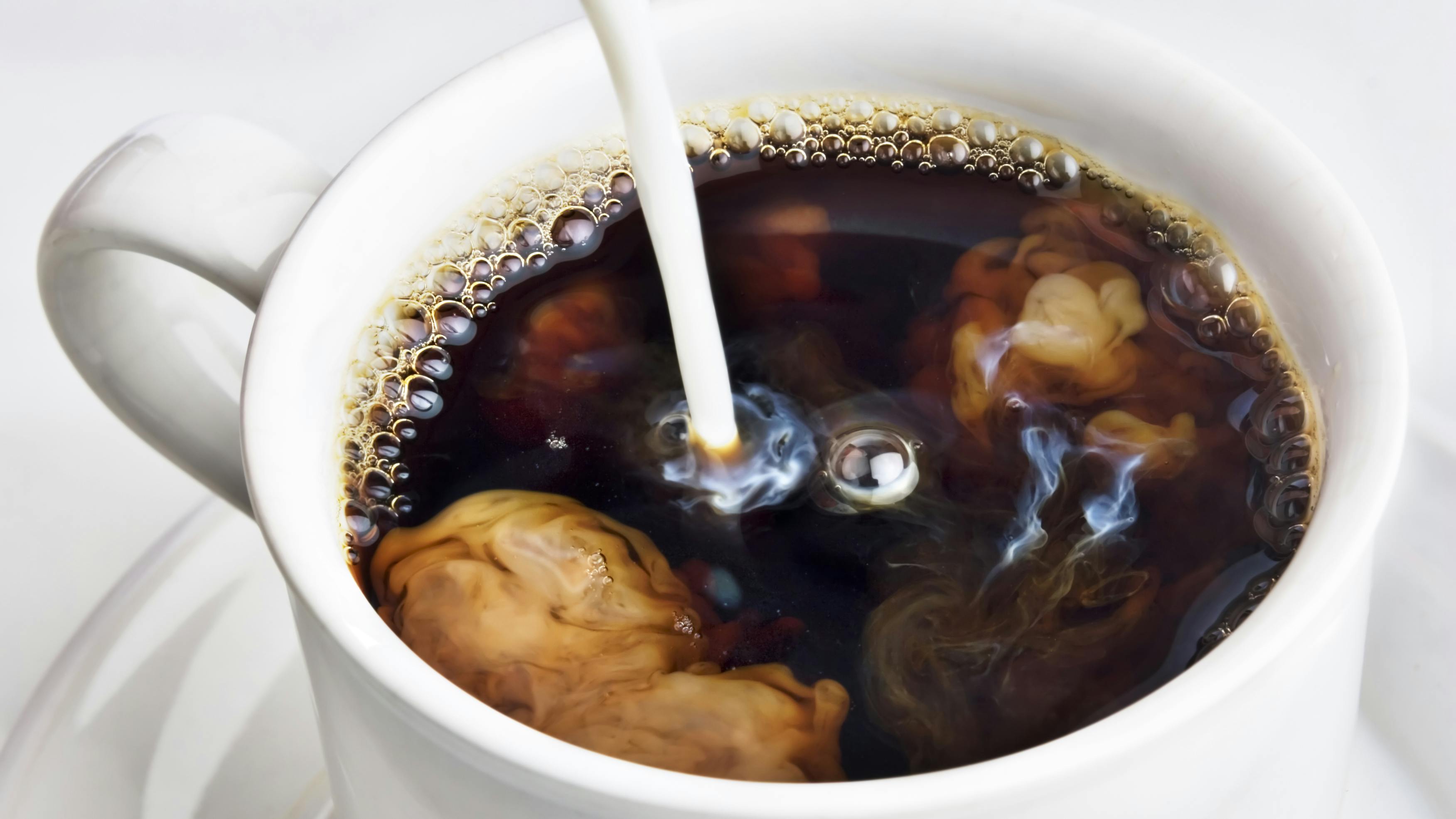 coffee into a cup of coffee stock image