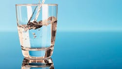 Drinking water is poured into a glass Drinking water is poured into a glass