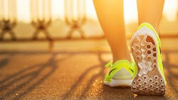 Runner woman feet running on road closeup on shoe. Female fitness model sunrise jog workout. Sports healthy lifestyle concept. Runner woman feet running on road closeup on shoe. Female fitness model sunrise jog workout. Sports healthy lifestyle concept.