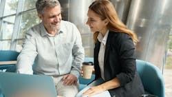 Two professionals in a contemporary office break area having a relaxed conversation, coffee cups in hand, Two professionals in a contemporary office break area having a relaxed conversation, coffee cups in hand,
