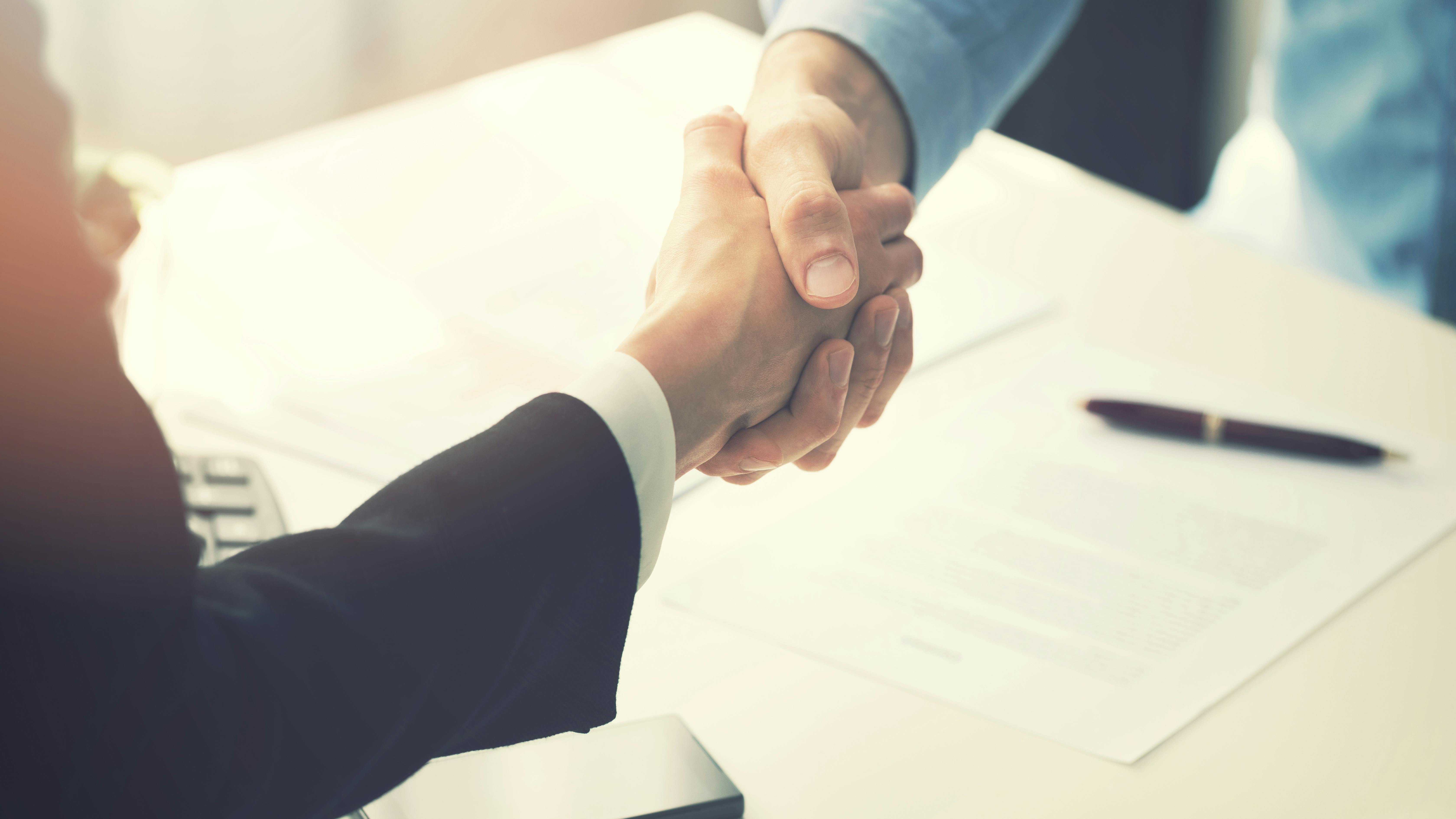 handshake across desk