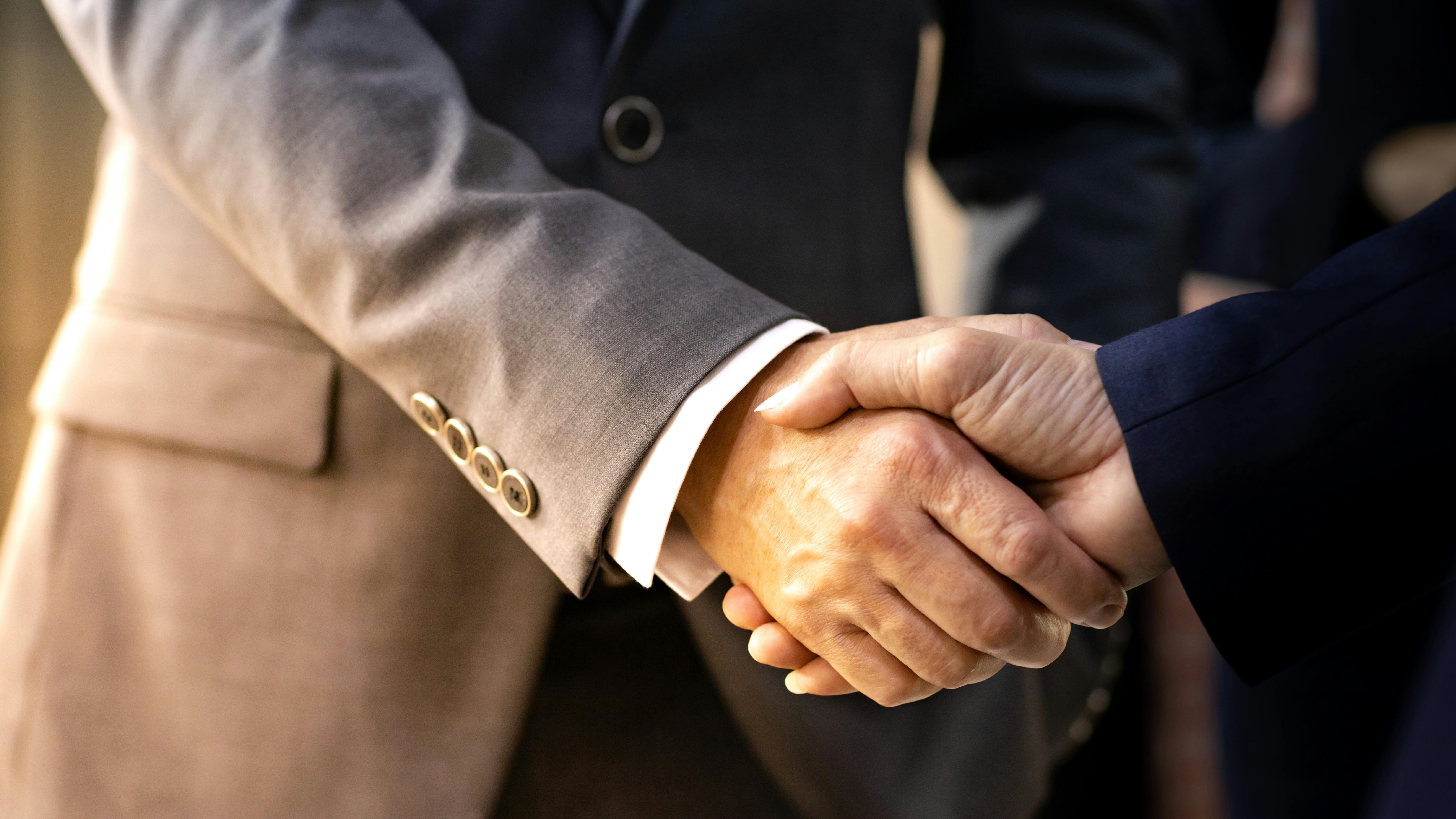 handshake stock image re mergers