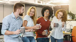 Group of Young Professionals Enjoying Coffee Break in Modern Office Space Together.